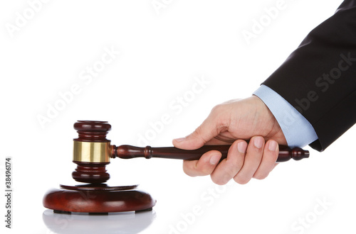 Foto: Human hand holding a wooden gavel Human hand holding a wooden gavel