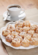 cookies sprinkled with sugar on a plate and a cup of coffee cookies sprinkled with sugar on a plate and a cup of coffee