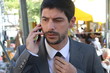 A young businessman is talking on his smartphone at the market