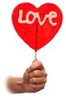 Woman hand with  red sweet valentine lollipop