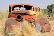 Old and rusty car wreck at the last gaz station before the Namib