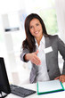 Portrait of beautiful smiling hostess giving handshake