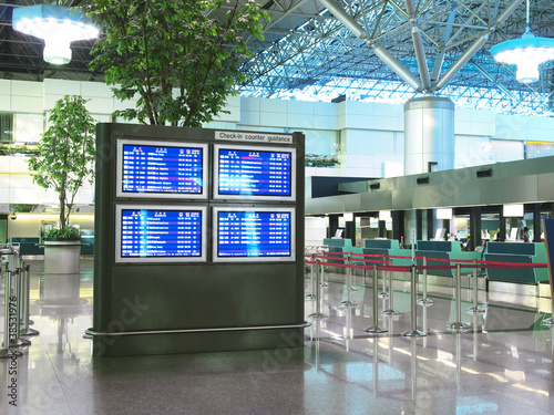 Photo: Flight schedule and check in counter in airport Flight schedule and check in counter in airport