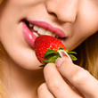 Photo: Woman eating mellow strawberry Woman eating mellow strawberry