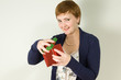 Redhead woman opening gift box