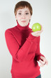 Quirky woman holding apple