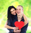 Happy couple with heart smiling outdoors Happy couple with heart smiling outdoors