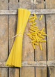 Foto: Raw pasta on wooden background Raw pasta on wooden background