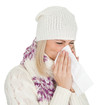 Woman in warm winter clothing sneezing from cold