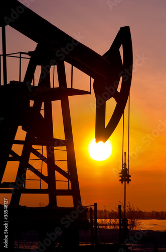 Photo: Oil pump rocker close to sunrise background Oil pump rocker close to sunrise background