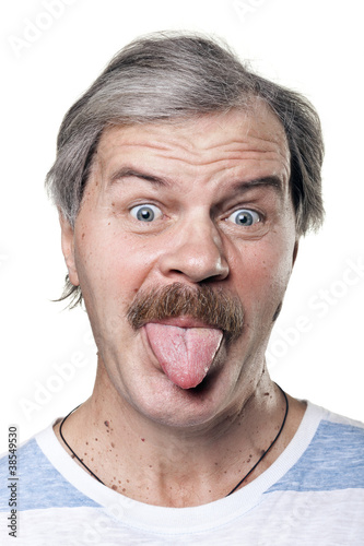 Photo: funny mature man shows tongue isolated on white background funny mature man shows tongue isolated on white background