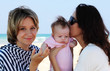two beautiful girls with a baby on the beach