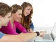 Friends surfing on the internet with touchpad and laptop Friends surfing on the internet with touchpad and laptop