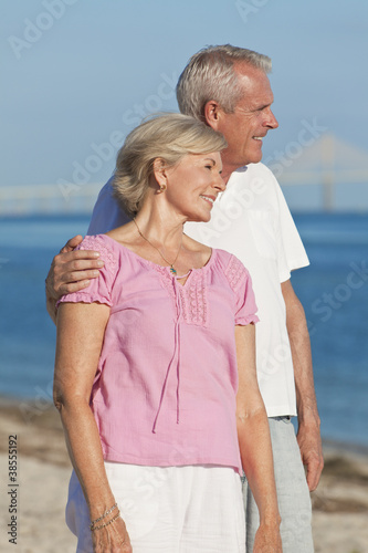 Photo: Happy Romantic Senior Couple Embracing on Beach Happy Romantic Senior Couple Embracing on Beach