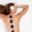 Woman getting  massage with hot stone.