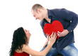 Young couple with a heart over white background Young couple with a heart over white background