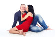 Happy young adult couple with red heart on the floor Happy young adult couple with red heart on the floor