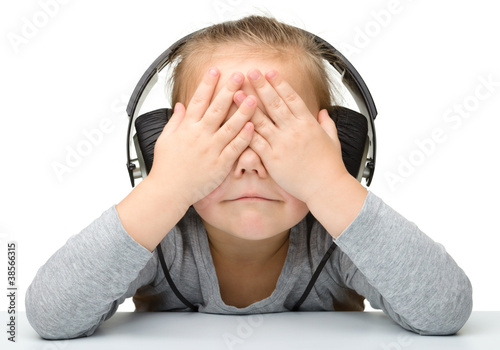 Headphones Hearing on Unhappy Girl Listening Music Using Headphones    Serhiy Kobyakov