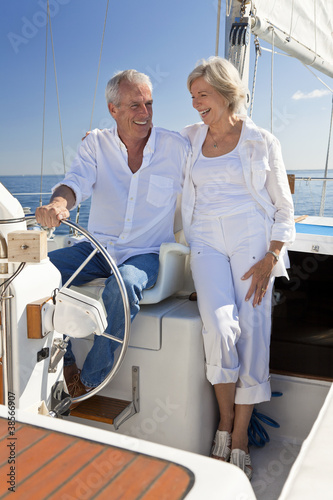 Foto: Happy Senior Couple At The Wheel of a Sail Boat Happy Senior Couple At The Wheel of a Sail Boat
