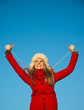 portrait of woman in red coat blue backgound