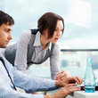 A business team of two colleagues planning work in office