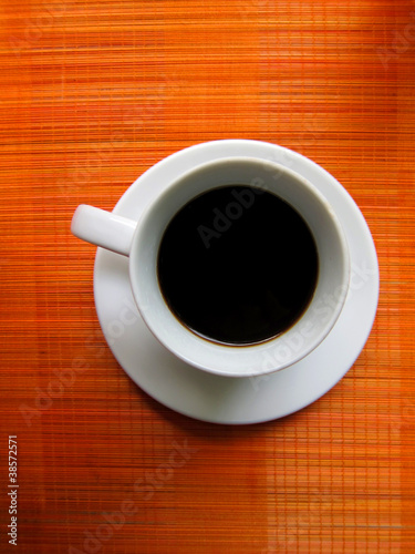 Photo: Cup of coffee on bamboo mat Cup of coffee on bamboo mat