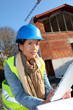 Architect on building site using electronic tablet Architect on building site using electronic tablet