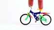Fingers ride on toy bike, other fingers came on fingerboard