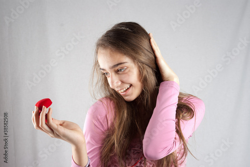 Photo: Teenage girl in pink with plush heart Teenage girl in pink with plush heart