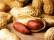 Peeled peanuts on well peanuts in background.