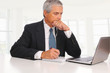 Middle Age Businessman at desk with Laptop