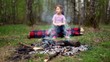 Little girl watch at bonfire burn, boy come and sit near