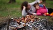 Mother and daugther lay on grass, kebab on foreground Mother and daugther lay on grass, kebab on foreground