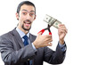 Man cutting money on white
