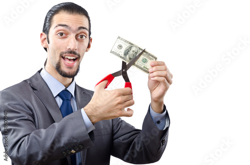Photo: Man cutting money on white Man cutting money on white