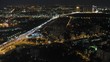 Cars go on night city which is shone by lanterns