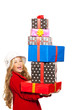 kid girl holding many gifts stacked on her hand