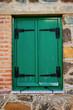 Window with wooden painted green shutters