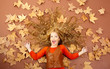 autumn fall little blond girl on dried tree leaves