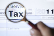 Tax form 1040 with magnifying glass