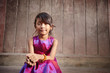 Cute and happy little Asian girl smiling at camera