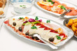 Slices of prosciutto, cheese and kulen sausage on silver plate