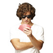 portrait of young man wearing sunglasses and playing poker over portrait of young man wearing sunglasses and playing poker over