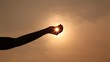 Video: hand silhouette holds sun on palm hand silhouette holds sun on palm