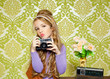 hip retro little girl shooting photo on vintage camera