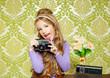 hip retro little girl shooting photo on vintage camera