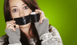 portrait of scared girl being silenced by herself over green bac