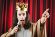 Funny king against red curtain Funny king against red curtain
