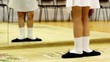 girl stand in front of mirror with legs in first position
