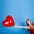 Photo: Cheerful woman with red heart Cheerful woman with red heart